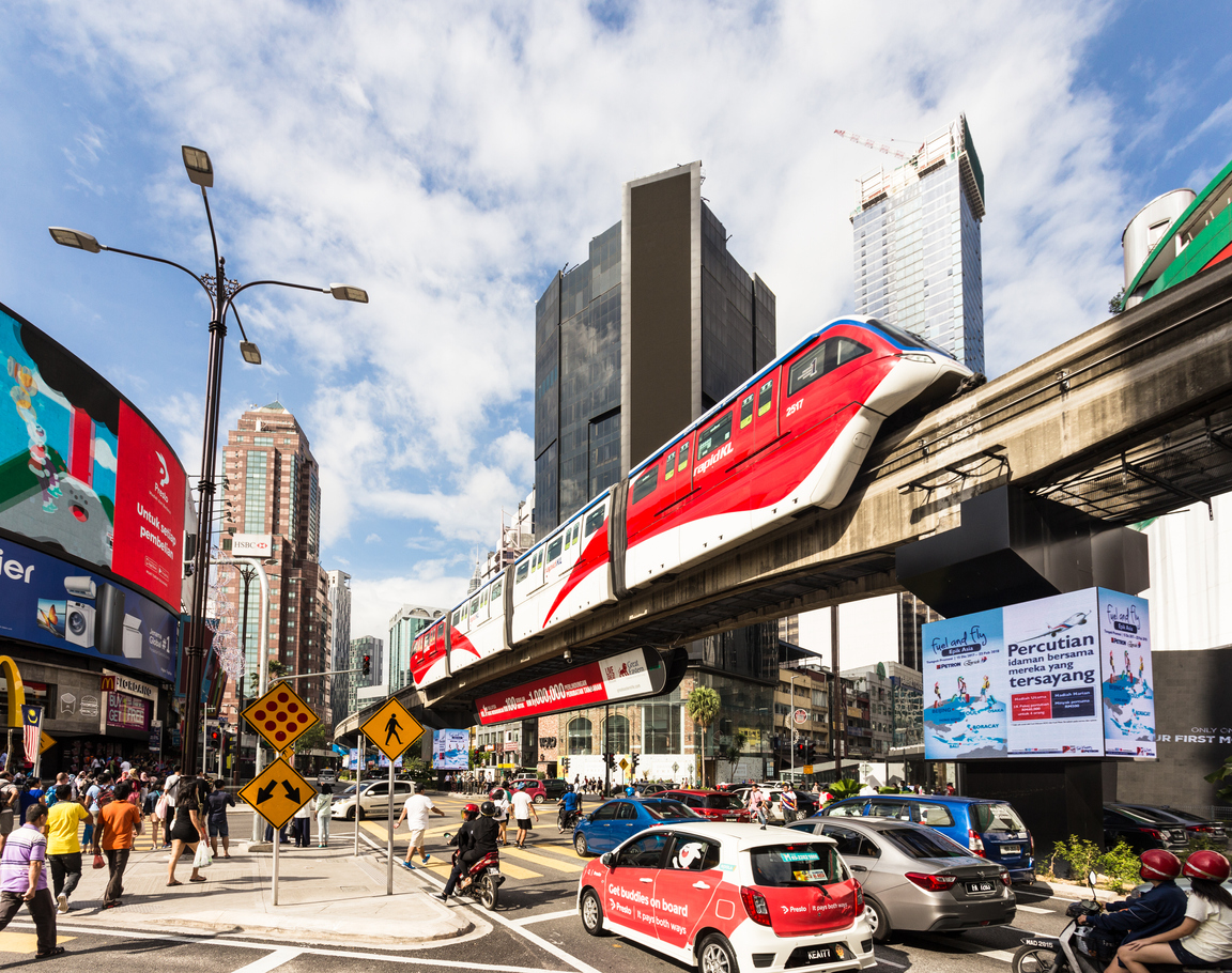 Cars and a monorail train rush through the Bukit Bintang intersection in the Golden Triangle area in the heart of Kuala Lumpur in Malaysia capital