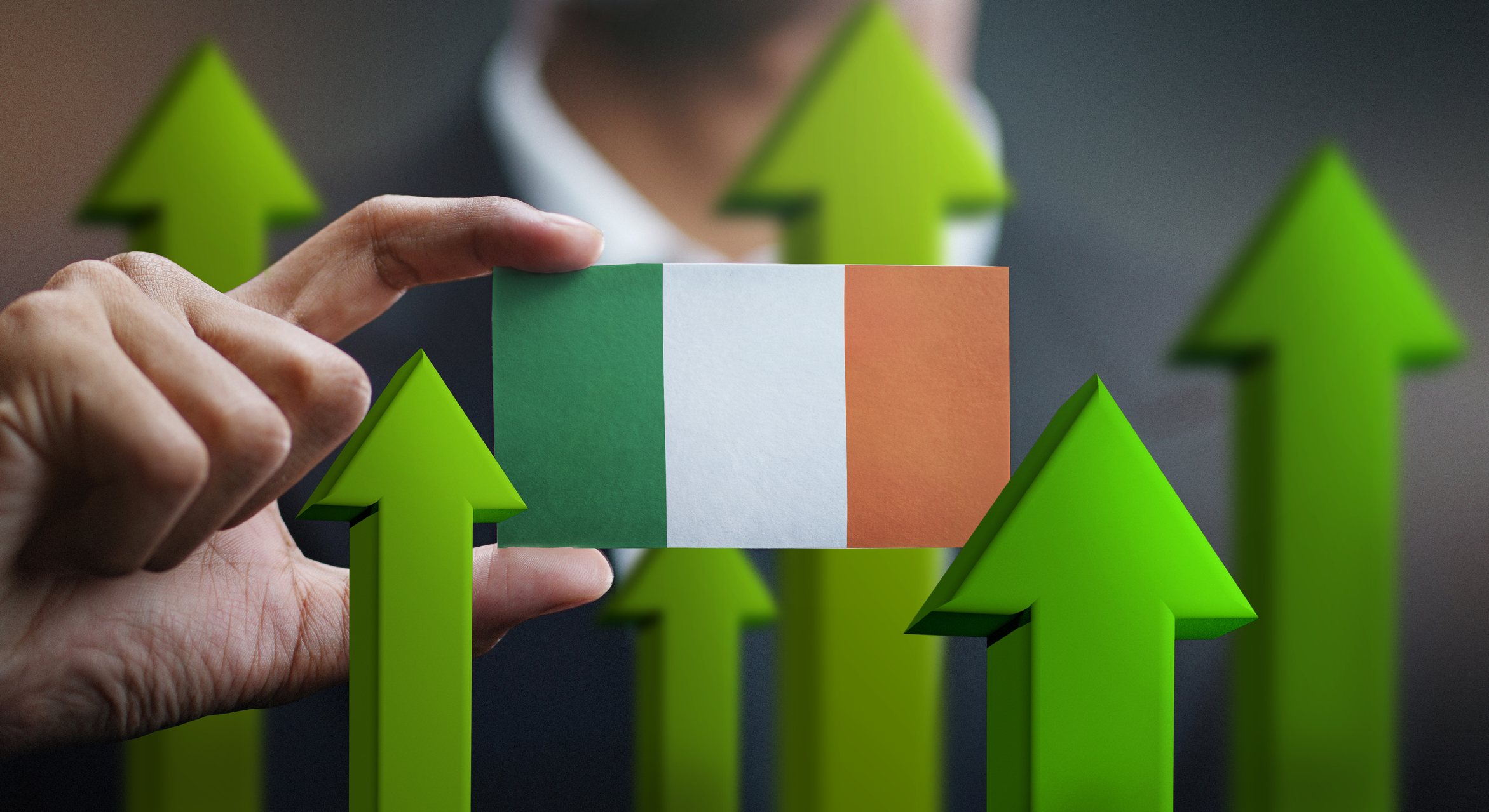 Nation Growth Concept, Green Up Arrows – Businessman Holding Card of Ireland Flag