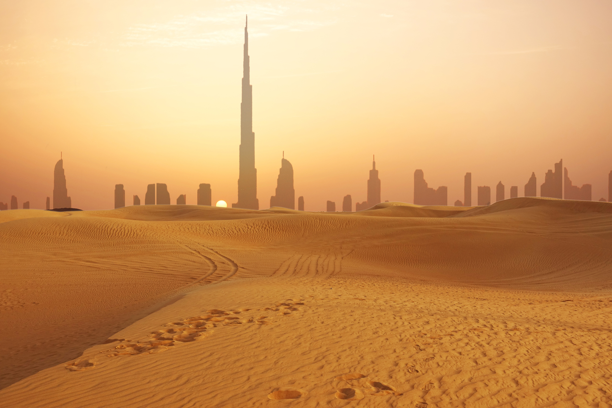 Dubai city skyline at sunset seen from the desert